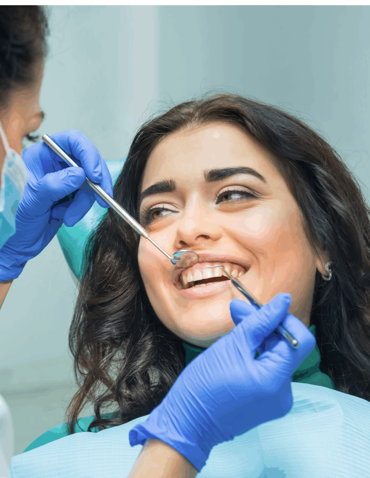 Dr. Viviana Mora smiling while providing a dental checkup at Mora Dental Studio in Brandon, FL