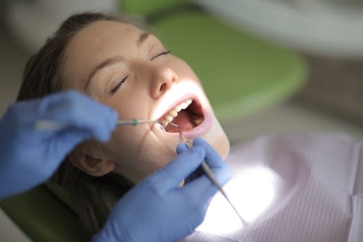 Close-up of the dentist Dr. Mora performing a dental check-up on a patient in a clinic.